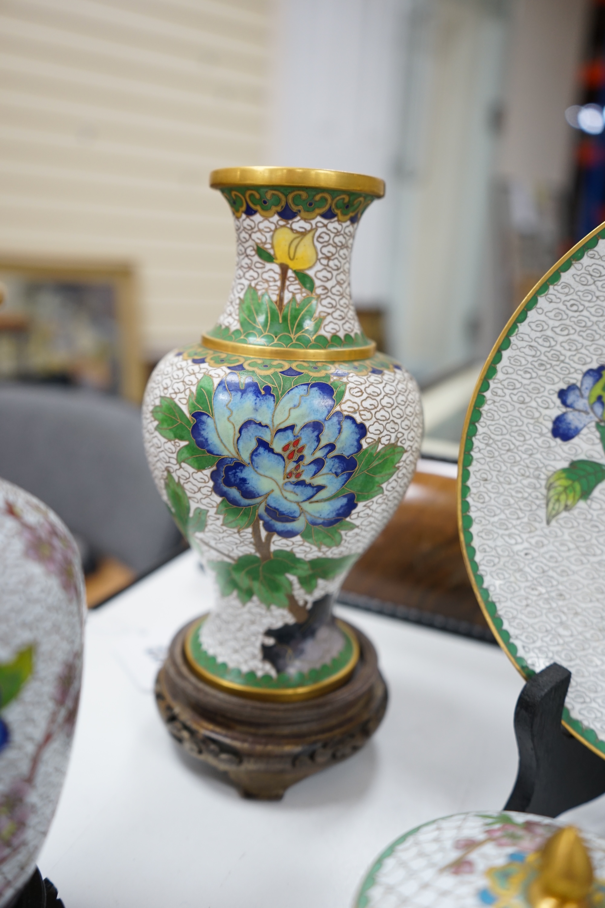 A collection of Chinese cloisonné enamel vases, pots etc., all worked on a white background in floral designs, plate, 20cm diameter. Condition - good